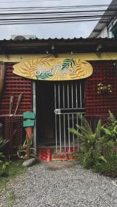 a surfboard sitting on the front of a building at Soul Rebel Hostel in Puerto Viejo