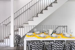a dining room with a table and chairs and a staircase at Central LA Escape Near Universal & Beaches in Los Angeles