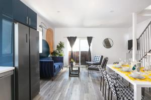a kitchen and living room with a table and chairs at Central LA Escape Near Universal & Beaches in Los Angeles
