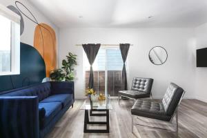 a living room with a blue couch and two chairs at Central LA Escape Near Universal & Beaches in Los Angeles +39 photos