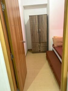 a door leading to a room with a closet at Urban haven Family&Barkada room in Manila +7 photos