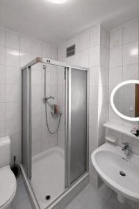 a bathroom with a shower and a toilet and a sink at Leo's Pension in Bad Schallerbach