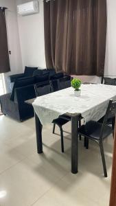 a white table and chairs in a living room at Casa com piscina in Araruama