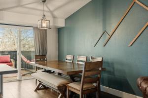 a dining room with a wooden table and chairs at The Loveland Haus in Loveland