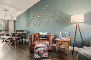 a living room with a chair and a table at The Loveland Haus in Loveland