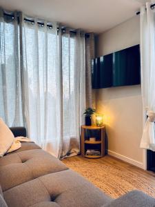 a bedroom with a bed and a television on the wall at Cape Byron Cabin in Coorabell Creek