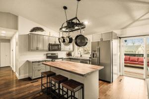 a kitchen with a kitchen island with stools in it at The Loveland Haus in Loveland