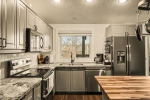 a kitchen with a stainless steel refrigerator and a counter at The Loveland Haus in Loveland +28 photos