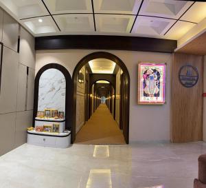 a hallway with an archway in a building at Hotel Vallabh Sky in Goya Gate