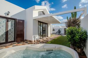 a house with a swimming pool in the yard at Casa Maurizio - Heated Pool, Hot Tub & Hammam in Playa Blanca
