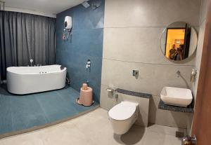 a bathroom with a tub and a sink and a toilet at Hotel Vallabh Sky in Goya Gate