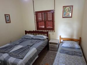 a bedroom with two twin beds and a window at Casa da lagoa in Imbituba +17 photos