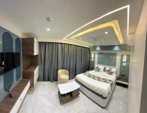 a hotel room with a bed and a television at Hotel Vallabh Sky in Goya Gate