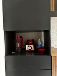 a counter with a coffee maker and a toaster at Prince House in Piracicaba