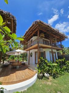a house with a wooden porch and a deck at Pangaro House in Katiet