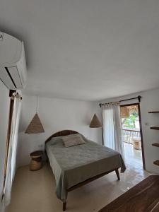 a bedroom with a bed and a window at Pangaro House in Katiet