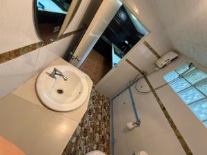 a bathroom with a white sink and a shower at MICKaL in Bang Hin Chang (1) +10 photos