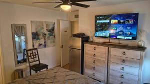 a bedroom with a dresser with a flat screen tv at Golden House in Santa Clarita