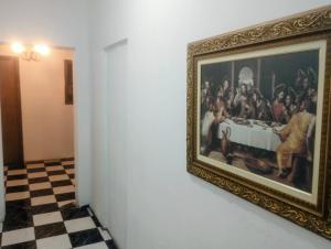 a painting hanging on a wall in a museum at Hotel BH Center in Belo Horizonte