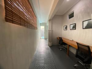 an empty office with a desk and a hallway at Villa Kulat in Uluwatu