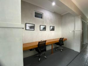 an office with a wooden desk and two chairs at Villa Kulat in Uluwatu +27 photos