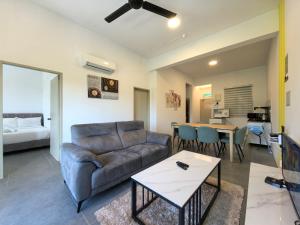 a living room with a couch and a table at Simfoni Comfy Premium 13 in Langkawi Islands