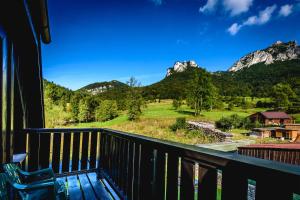 a room with a balcony with a view of mountains at Penzion Sagan in Terchová