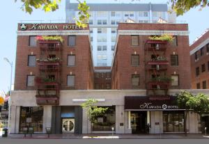 a large brick building with balconies on a street at Kawada Hotel in Los Angeles