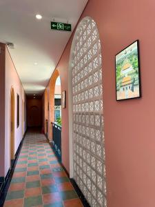 a hallway in a building with a wall with a window at DEE Homestay in Hue