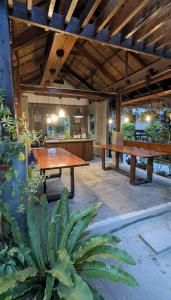 a patio with two large wooden tables in a building at Villa Peray Siargao in General Luna