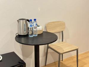 a table with a coffee maker and water bottles on it at บ้านสุดซอย-Baan Sud Soi in Prachuap Khiri Khan