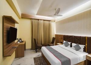 a hotel room with a bed and a television at Hotel Dream Patna in Patna