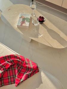 a table with wine glasses and a book on it at Azur Stay in Kwangan-dong +49 photos