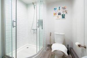 a white bathroom with a shower and a toilet at Non Inn The Diamond Artisan and Barber 4 Bedroom Riverside Retreat with King and Twin Rooms in Bang Rak +21 photos