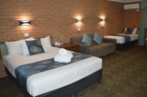a hotel room with two beds and a couch at James Street Motor Inn in Toowoomba +52 photos