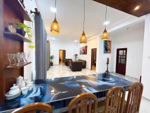 a dining room with a blue table and chairs at Blessora Sky Retreat in Kalutara