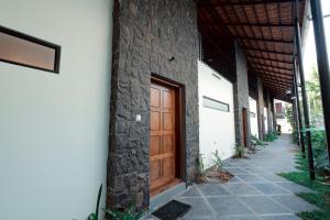 a wooden door on the side of a building at G' de CASA in Varkala