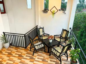 a porch with four chairs and a table at Blessora Sky Retreat in Kalutara +6 photos
