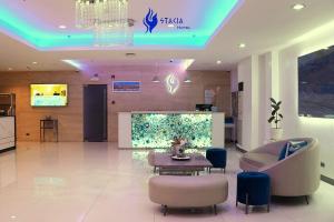 a lobby of a hospital with a table and a couch at Stacia Hotel in Cebu City