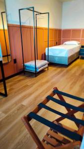 a room with two bunk beds and a wooden floor at Hotel Lagoa in Laguna