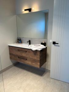 a bathroom with a sink and a mirror at The Top Place Retreat in Caveside +28 photos