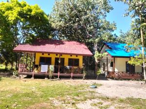 a small house with a red roof at Papua Risen Beach Front Bungallow in Insyurifuri