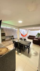 a dining room with a table and chairs at Comfortable house in Natal in Natal +17 photos