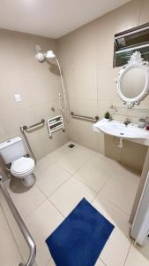 a bathroom with a toilet and a sink and a mirror at Comfortable house in Natal in Natal