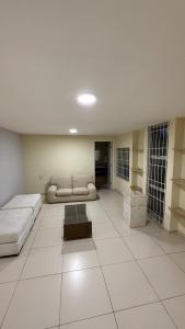 a large living room with a couch and a table at Comfortable house in Natal in Natal