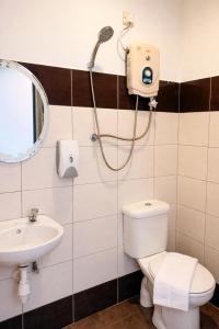 a bathroom with a shower and a toilet and a sink at EL Zahraa Moda Hotel Alor Setar in Alor Setar