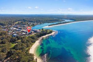 a hot air balloon flying over a beach at ParkView on Owen in Huskisson +2 photos