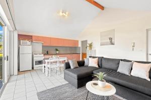 a living room with a couch and a table at ParkView on Owen in Huskisson