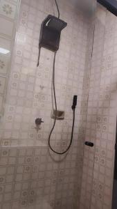 a black phone on a wall in a bathroom at Hotel Lagoa in Laguna +43 photos