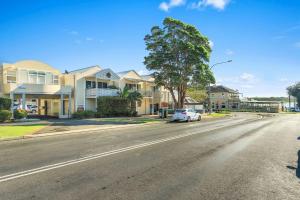 a white car parked on the side of a street at ParkView on Owen in Huskisson